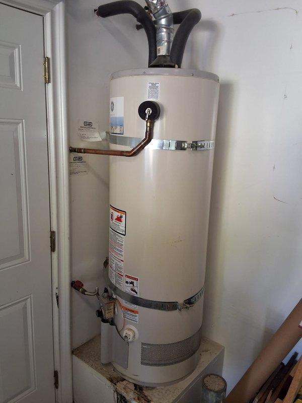 Replaced a leaking 2009 GE 50-gallon residential water heater (model GG50T09AVH00) located in the garage with a new 50-gallon gas water heater (model GN50T1-3-6). Installation included all necessary code compliance modifications, proper venting connections, earthquake restraint strapping, copper piping connections, and safety valve installation. Permit was obtained for the replacement to ensure compliance with local building codes.