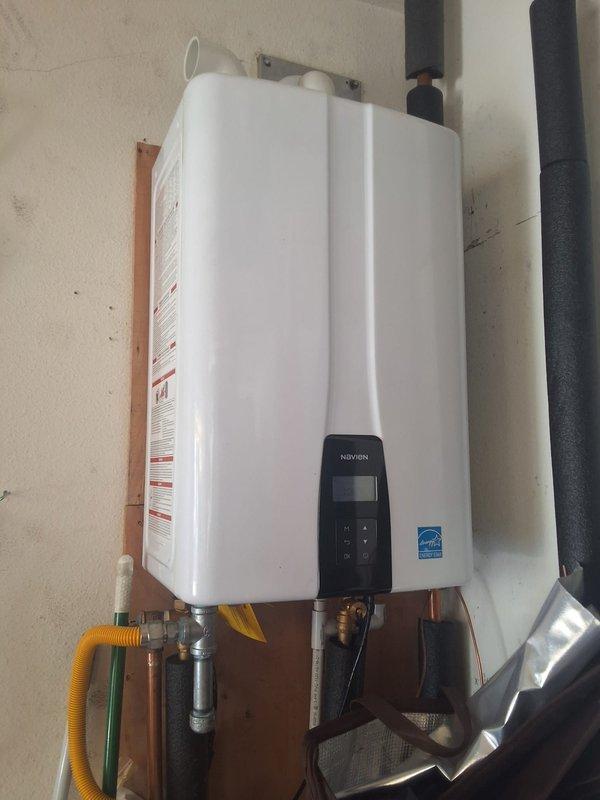 Completed warranty service for recently installed Navien NPE240A2 tankless water heater requiring gas system documentation and verification. Mapped entire residential gas distribution system, documenting all gas appliances with corresponding BTU ratings and gas line lengths from meter to each appliance. Verified proper installation of tankless unit including yellow CSST gas supply connection, venting configuration with dual black exhaust/intake pipes, and all water connections. Photographed gas meter assembly under deck structure showing distribution piping and valve configuration. Created comprehensive gas diagram showing routing, sizing, and load calculations for all appliances connected to system to ensure adequate gas supply and code compliance for the new tankless water heater installation.