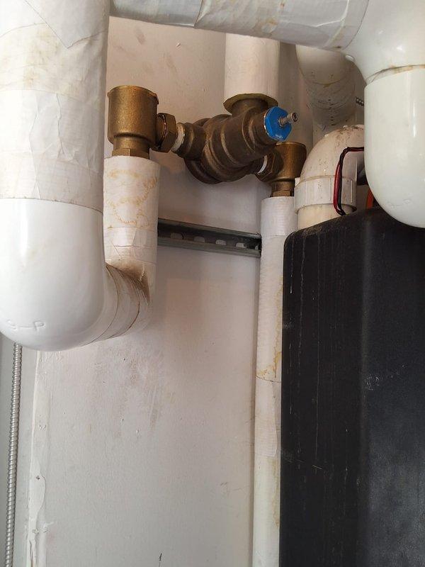 Inspected two approximately 12-year-old Rheem Commercial GHE100ES-400 water heaters in the utility room and documented their condition, including aged and stained piping insulation, discolored PVC runs, loose wrap, and general wear at the units and associated plumbing. Units are at end of service life and recommended for replacement; site measurements and photos were gathered to support a replacement bid, with installation to be scheduled on-site for the earliest available window.