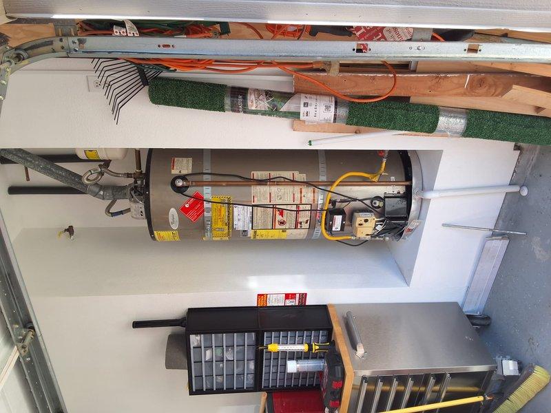 Performed an on-site inspection and replacement estimate for an aging 50-gallon gas-fired tank water heater; no model or serial data was available, and the unit was documented with photos, including corrosion buildup on the gas shutoff valve and flexible gas connector fitting. Discussed replacement of a 50-gallon gas water heater, including permit requirements and available payment options, and provided a ballpark estimate for the work.