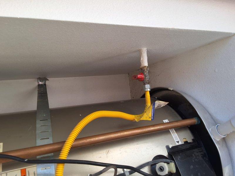 Performed an on-site inspection and replacement estimate for an aging 50-gallon gas-fired tank water heater; no model or serial data was available, and the unit was documented with photos, including corrosion buildup on the gas shutoff valve and flexible gas connector fitting. Discussed replacement of a 50-gallon gas water heater, including permit requirements and available payment options, and provided a ballpark estimate for the work.
