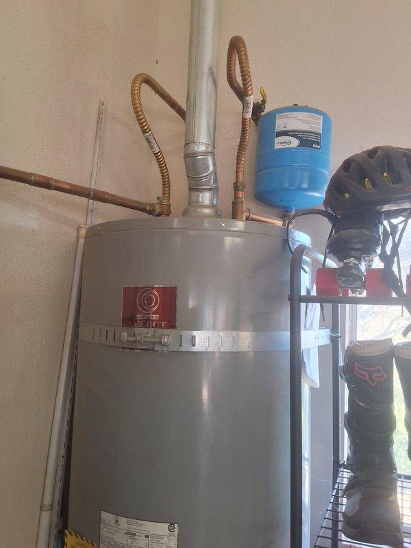 Replaced a 2012 50-gallon atmospheric gas water heater in the garage that had a no-pilot condition with a new State Select 50-gallon unit, including new flexible water and gas connectors, a new expansion tank, and a rigid vent connection. Secured the tank with seismic strapping, verified proper venting, gas tightness, and operation, and confirmed there were no leaks. Permit requirements were discussed with the customer.