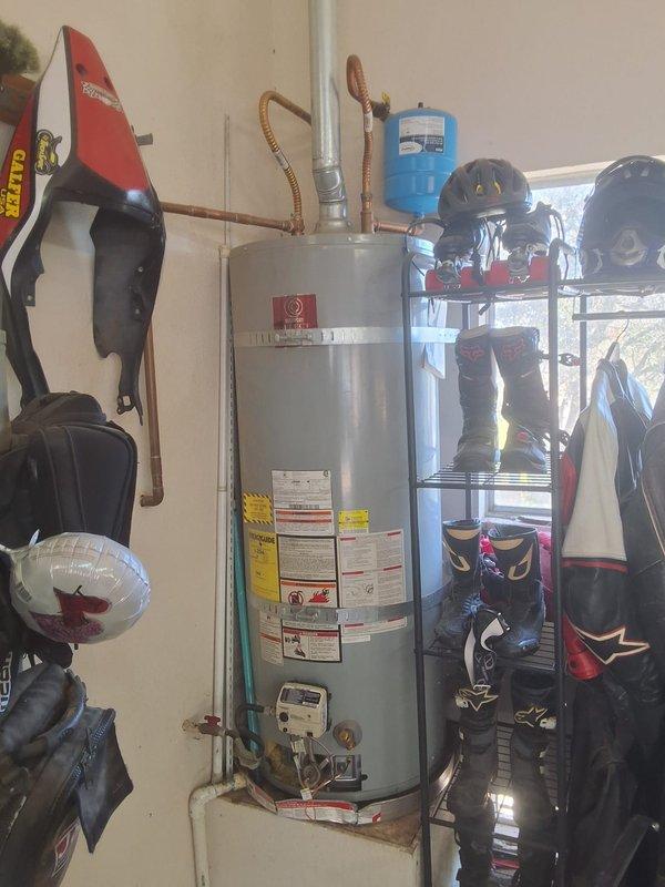 Replaced a 2012 50-gallon atmospheric gas water heater in the garage that had a no-pilot condition with a new State Select 50-gallon unit, including new flexible water and gas connectors, a new expansion tank, and a rigid vent connection. Secured the tank with seismic strapping, verified proper venting, gas tightness, and operation, and confirmed there were no leaks. Permit requirements were discussed with the customer.