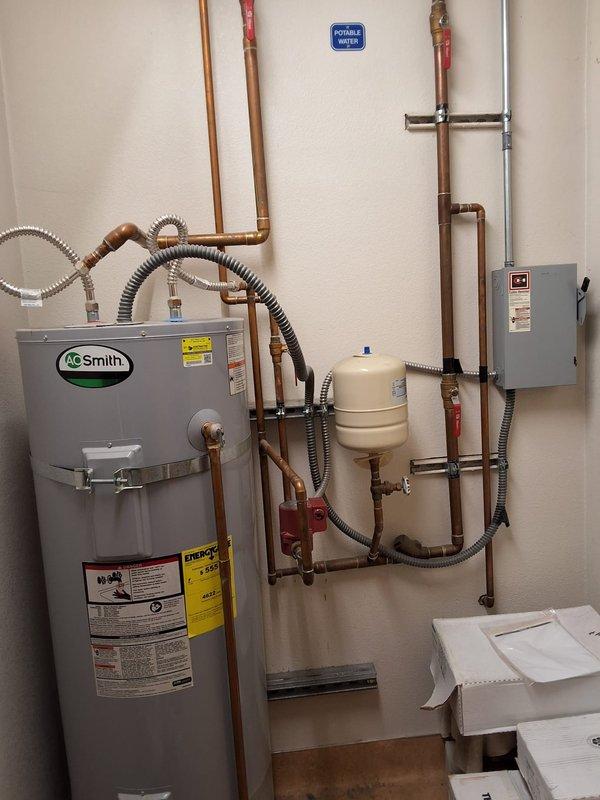 Evaluated a reported no-hot-water condition on a 2016 A.O. Smith 100-gallon commercial water heater serving an office building kitchen and four restrooms. Inspected the tank, discharge piping, expansion tank, recirculation pump, and electrical disconnect, documented the installation with photos, and provided a free estimate for replacement, including permitting requirements.