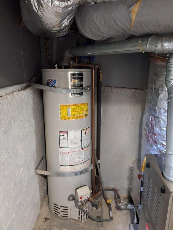 Replaced a failed 50-gallon gas water heater in a basement utility closet, including disconnection and removal of the old unit, installation of the new tank on the existing pad, and reconnection of the gas supply with flexible gas connector, copper water lines, and flue venting. Secured the tank with seismic straps and verified proper combustion, venting, and leak-free connections, with permit requirements reviewed prior to installation.