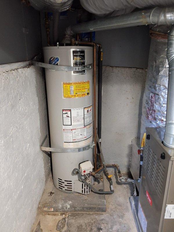 Replaced a failed 50-gallon gas water heater in a basement utility closet, including disconnection and removal of the old unit, installation of the new tank on the existing pad, and reconnection of the gas supply with flexible gas connector, copper water lines, and flue venting. Secured the tank with seismic straps and verified proper combustion, venting, and leak-free connections, with permit requirements reviewed prior to installation.