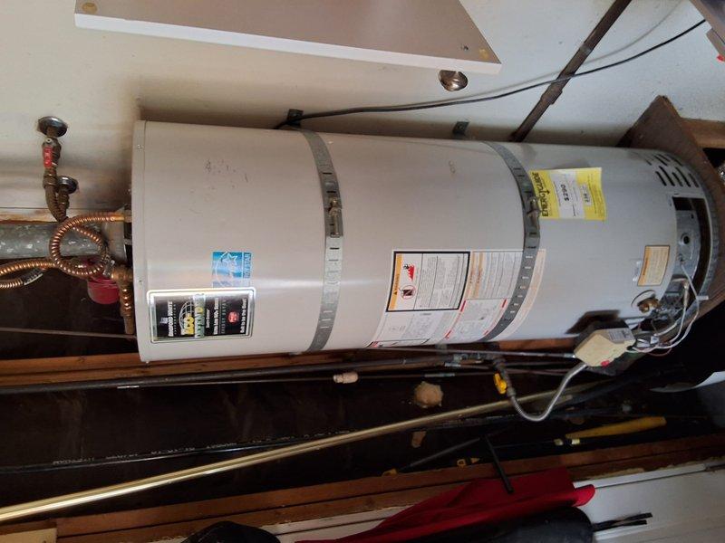 Performed an on-site inspection of the existing 50-gallon natural gas water heater to evaluate it for replacement and prepare an estimate for a Bradford White URG250T6N unit. Documented the installation, including the strapping, gas control valve and flexible gas connector, vent connection, copper supply and shutoff valves, and platform mounting, and found no visible rust, leaks, or tank damage. Existing unit data plate details and permit requirements were not confirmed, so the replacement scope is pending verification of those items.