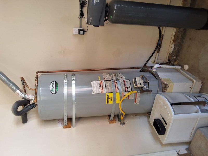 Performed a preventive inspection and estimate for replacement of a 50-gallon gas water heater (A.O. Smith, approximately 2014 manufacture). Observed corrosion and mineral staining on the copper supply piping at the tank top, along with a scorch mark on the wall near the inlet piping, and documented all conditions with photos. Reviewed replacement options with a like-for-like 50-gallon gas unit, discussed permit requirements, and provided a ballpark estimate for the work and available payment methods.