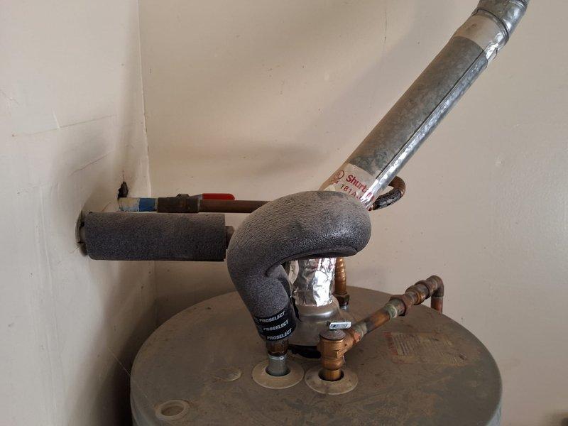 Performed a preventive inspection and estimate for replacement of a 50-gallon gas water heater (A.O. Smith, approximately 2014 manufacture). Observed corrosion and mineral staining on the copper supply piping at the tank top, along with a scorch mark on the wall near the inlet piping, and documented all conditions with photos. Reviewed replacement options with a like-for-like 50-gallon gas unit, discussed permit requirements, and provided a ballpark estimate for the work and available payment methods.