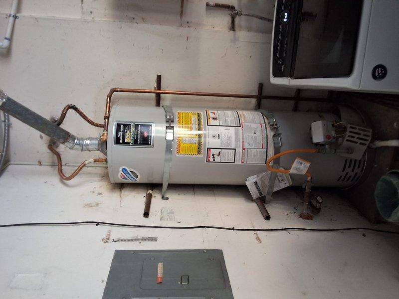 Performed a preventive replacement evaluation of a 10-year-old 50-gallon gas water heater, inspecting the tank, gas control valve, flexible gas connector, and copper water supply lines. Presented replacement options for both a like-for-like 50-gallon gas storage unit and a tankless conversion, and reviewed permit requirements and available payment methods.