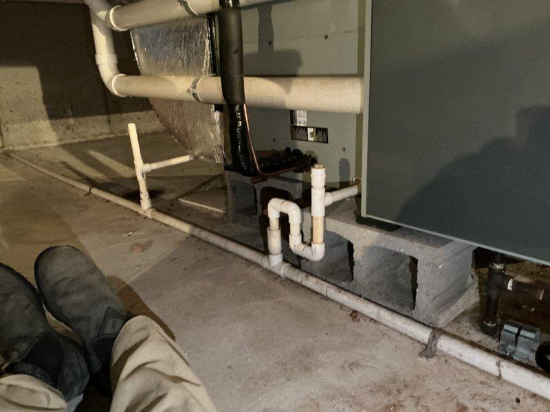 Returned to site to collect additional data for estimate and load calculation. Documented electrical panel configuration, noting multiple 20-amp breakers with QO markings and breaker positions. Also photographed plumbing and HVAC systems in utility area, including PVC drainage pipes, P-trap configuration, and furnace placement for comprehensive assessment.