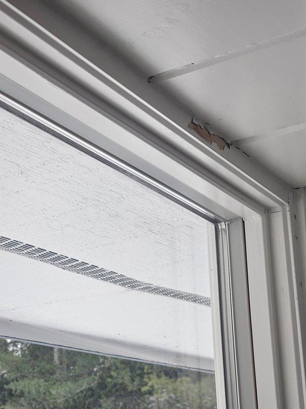 Responded to humidity issue in residence with 28% indoor humidity reading on Honeywell thermostat. Inspected property and documented damage to wooden elements including peeling wood and splitting walls. Observed window frame damage with paint chipping and exposed underlying wood, consistent with low humidity conditions.