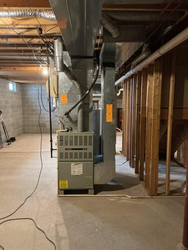 Completed furnace estimate in unfinished basement with existing HVAC system. Assessed current unit and ductwork configuration for potential replacement options. Documented installation environment including electrical access and existing distribution system for comprehensive proposal preparation.