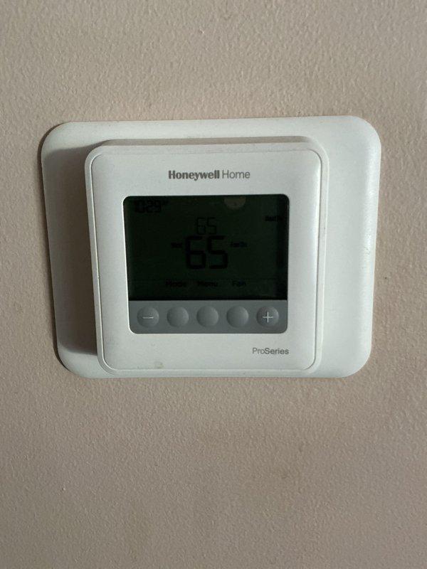 Conducted AC estimate for customer by evaluating existing HVAC system, which includes a Honeywell Home ProSeries thermostat and basement-located furnace unit with associated ductwork. Took comprehensive photos of the thermostat and furnace installation to document current setup for proper system sizing and replacement recommendations.