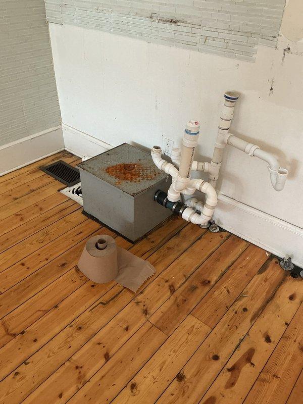 Conducted site assessment for bathroom decommissioning project, which includes capping water supply lines and drain pipes for sink removal, and sealing the waste line connections. Noted existing PVC drainage system with visible corrosion on metal drain assembly that requires proper termination. Evaluated wall repair needs where fixtures will be removed and documented damaged drywall areas requiring remediation after plumbing work is completed.