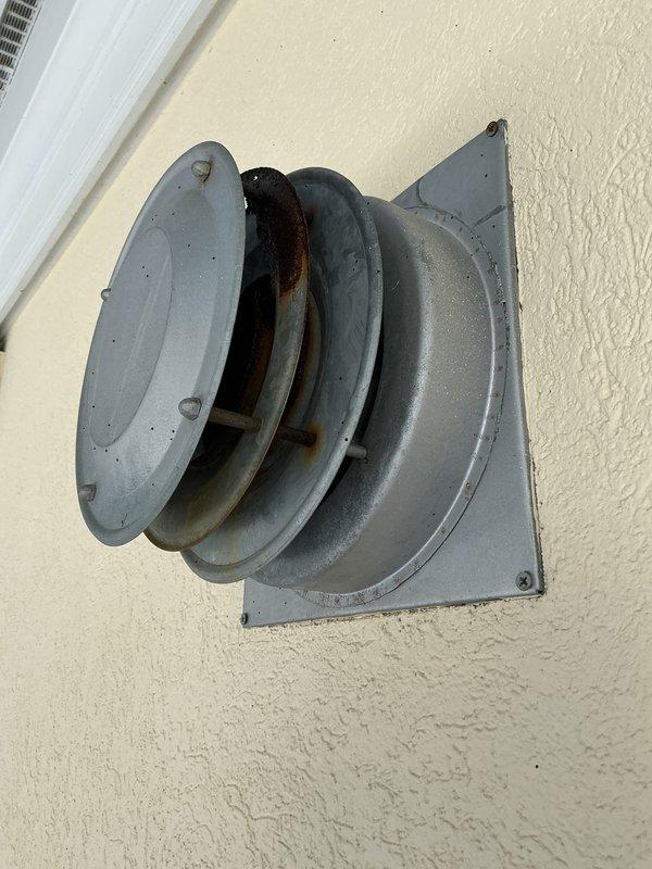 Inspected unit heater and identified a crack in the heat exchanger at the transition point to the exhaust hood. System was immediately shut down and gas supply terminated due to safety hazard from potential carbon monoxide leakage into supply air. Documented condition with photos of the ventilation fixture and gas meter assembly.