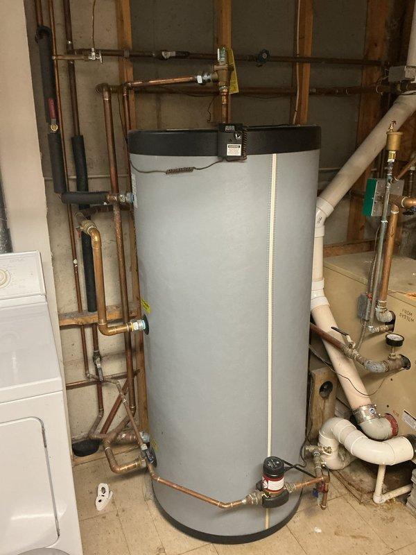 Inspected bottom-fed water heater installation and identified code violations requiring correction. System needs installation of vacuum relief valves per P2804.7 code requirements, and an ASSE 1017 mixing valve must be installed on domestic water side according to manufacturer instructions and P2803.2 standards. Service proposal PP2023-0326 was disapproved pending these mandatory corrections.