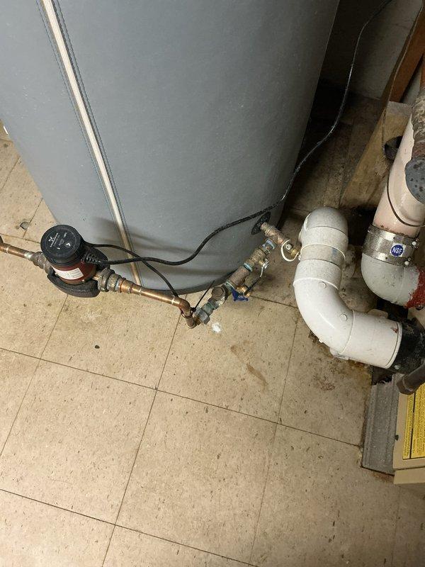 Inspected bottom-fed water heater installation and identified code violations requiring correction. System needs installation of vacuum relief valves per P2804.7 code requirements, and an ASSE 1017 mixing valve must be installed on domestic water side according to manufacturer instructions and P2803.2 standards. Service proposal PP2023-0326 was disapproved pending these mandatory corrections.