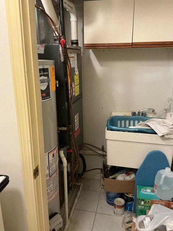 Completed on-site evaluation for furnace and air conditioning system replacement in residential property. Assessed existing HVAC equipment in basement utility area, documented current system specifications, and photographed installation location to prepare comprehensive estimate for new heating and cooling equipment installation.