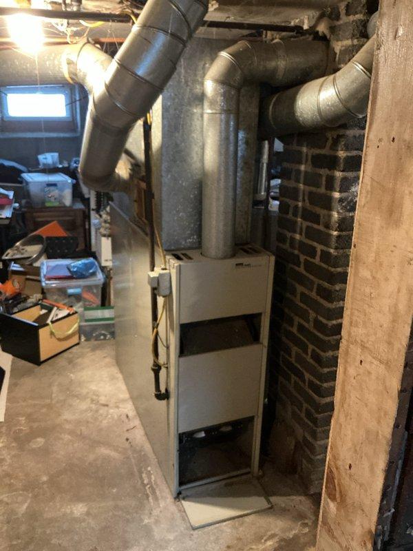 Conducted comprehensive sales estimate for furnace replacement and potential air conditioning system installation at residential property. Performed thorough assessment of existing basement HVAC equipment, including aging furnace unit with gray metal ductwork system extending from top of unit through exposed ceiling joists. Evaluated current mechanical room configuration, noting exposed brick walls, concrete flooring, and existing utility infrastructure including water heater and associated plumbing connections. Documented equipment conditions through detailed photography to support replacement recommendations. Provided customer with professional options for new furnace installation and discussed potential AC system integration with existing ductwork layout.