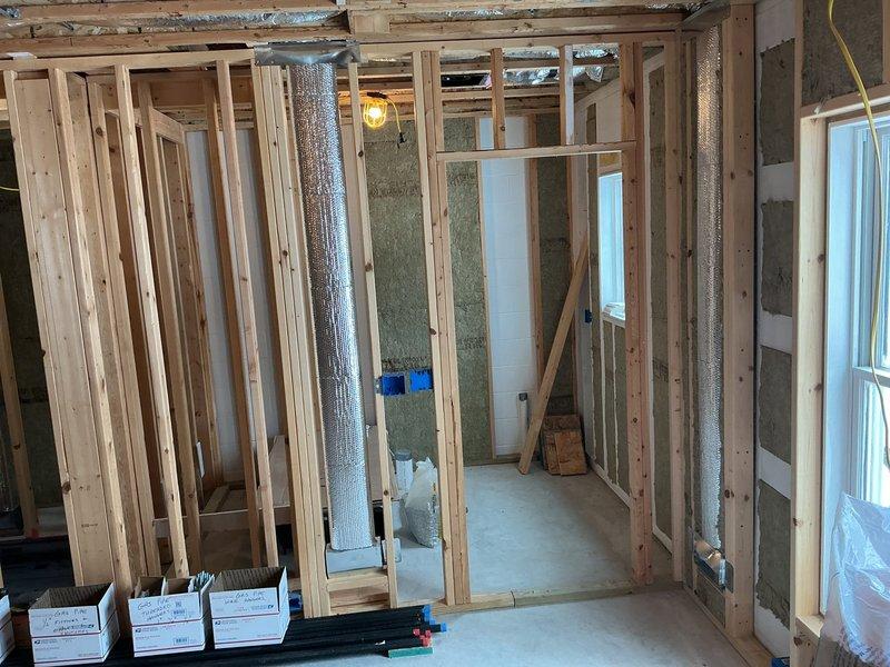 Conducted site assessment for complete HVAC system installation in unfinished residential construction. Documented existing conditions including exposed framing, partial insulation installation, and current water heater specifications. Comprehensive photographs were taken of the basement area showing spray foam and foil-backed insulation, exposed ductwork, and mechanical equipment to facilitate internal review for project feasibility and system design requirements.