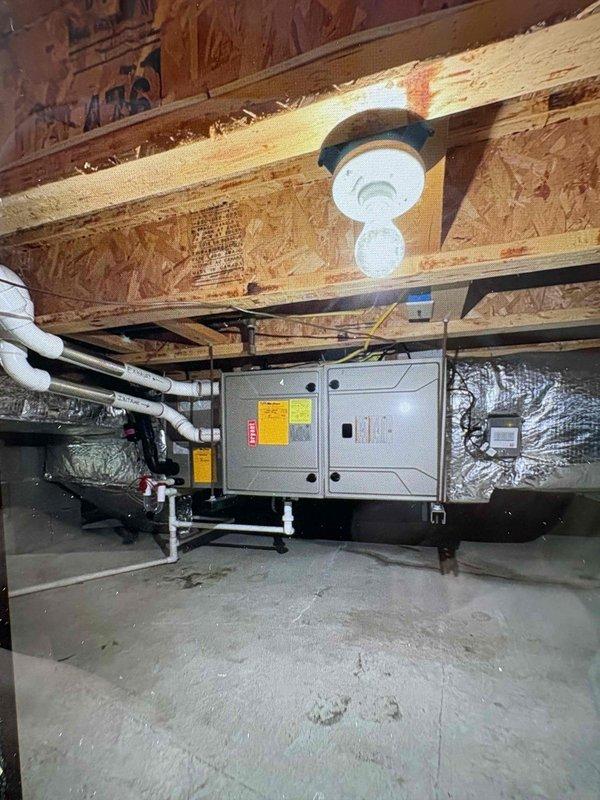 Completed installation of replacement furnace unit in crawlspace with proper PVC condensate drainage and venting systems. Initial condenser unit received damaged and was removed from job to process manufacturer return, with replacement unit ordered and received for future installation. All furnace components properly installed with appropriate electrical connections, reflective ductwork insulation, and code-compliant configuration in confined space environment.