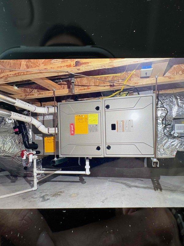 Completed installation of replacement furnace unit in crawlspace with proper PVC condensate drainage and venting systems. Initial condenser unit received damaged and was removed from job to process manufacturer return, with replacement unit ordered and received for future installation. All furnace components properly installed with appropriate electrical connections, reflective ductwork insulation, and code-compliant configuration in confined space environment.