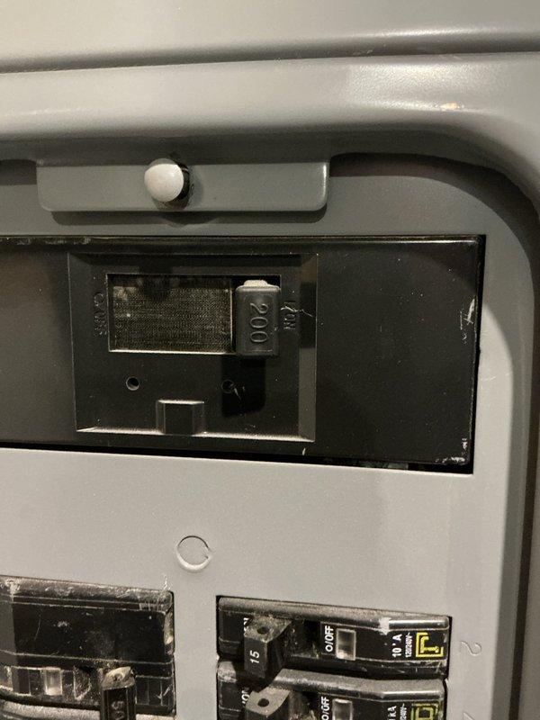 Conducted on-site evaluation for standby Generac generator installation. Documented existing electrical infrastructure including main service panel with Square D circuit breakers rated at 200A capacity. Photographed current electrical panel configuration showing dual-column breaker arrangement with handwritten circuit directory identifying all branch circuits including surge protection, basement receptacles, and bathroom circuits. Assessed panel capacity and available space for generator transfer switch integration to determine equipment specifications and installation requirements for automatic backup power system.