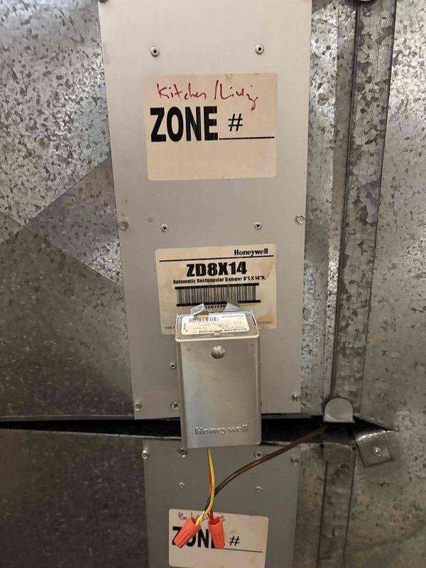 Responded to complaint of uneven heating between zones, with one zone reaching 88°F while another only achieved 52°F. Inspected Honeywell ZD8X14 automatic switchover 8-zone control panel and associated zone dampers. Documented equipment including zone controller and ART10 Honeywell zone damper for Zone #1. Purged air from affected zone's heating loop to restore proper circulation and heat distribution. Verified zone controller operation and damper functionality. Photographed equipment for client records and noted equipment information previously missing from account. System restored to proper multi-zone operation with balanced heat distribution across all zones.