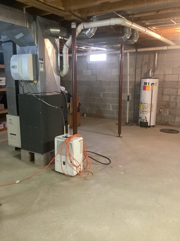 Completed annual heating maintenance and preventive tune-up on Amana furnace system in basement utility area. Performed comprehensive inspection of furnace unit, ductwork connections, and associated HVAC components. Verified proper operation of heating system, checked all electrical connections, inspected heat exchanger, tested safety controls, and cleaned burner assembly. Documented equipment age and updated service records with unit information. All mechanical systems including furnace, water heater, and humidifier found to be operating within normal parameters with no immediate repairs required at time of service.