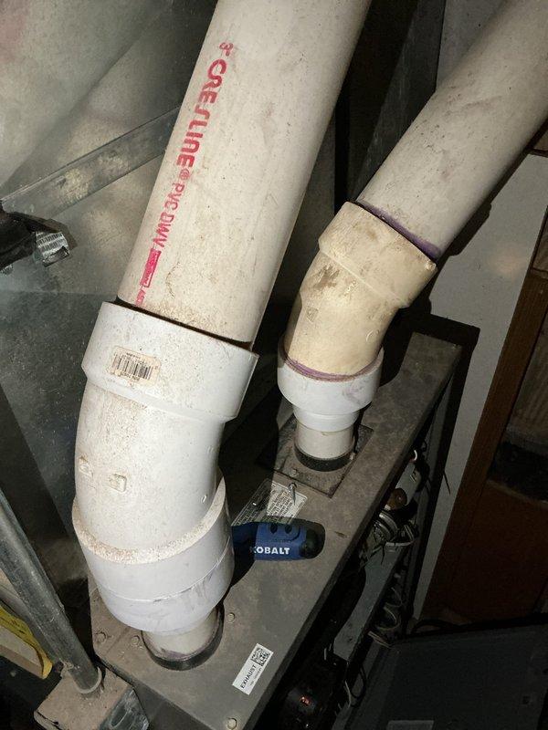 Conducted on-site evaluation of existing HVAC system for furnace and air conditioning replacement estimate. Assessed current heating setup including wood-burning stove and associated ductwork in mechanical room. Documented existing equipment configuration, venting systems, and spatial constraints for proposed system installation. Evaluated PVC drainage and venting infrastructure along with electrical components to determine compatibility requirements for new HVAC equipment.