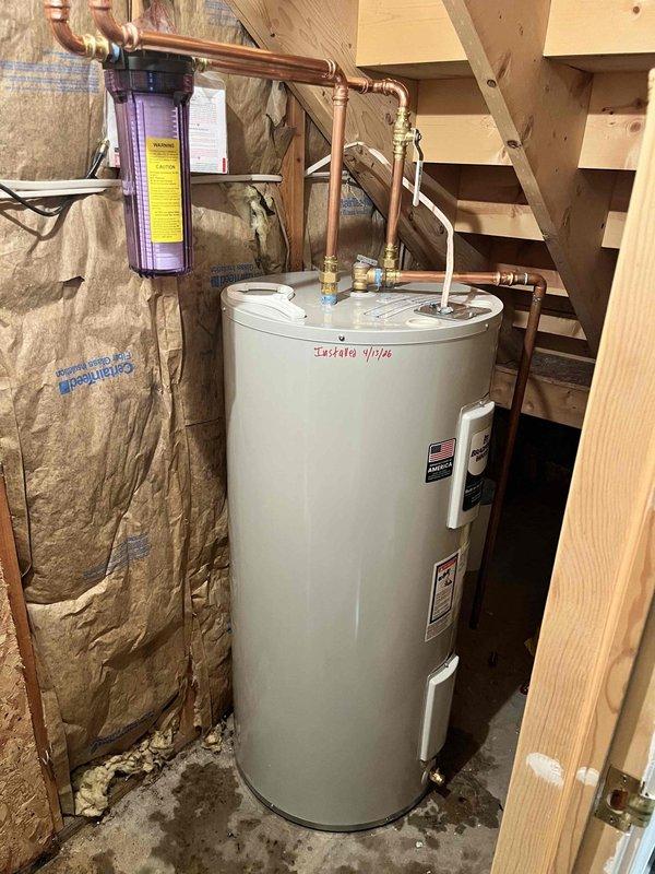 Installed 40-gallon residential water heater and whole house water filtration system in basement utility area. Repaired split copper pipe near water heater location. All plumbing connections completed with copper piping, appropriate valves and fittings installed per code, system tested and verified operational.