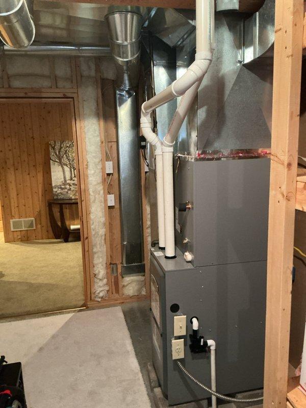 Performed estimate for air conditioning installation at residential property currently equipped with forced air furnace only. Assessed existing HVAC infrastructure including gas furnace unit, ductwork system, and electrical panel capacity. Documented mechanical room layout with exposed framing in basement utility area, noting PVC venting, galvanized metal ductwork distribution, and available space for AC system integration. Evaluated electrical service panel to confirm adequate breaker capacity and available circuits for air conditioning equipment installation. Provided recommendations for complete central air conditioning system addition to work in conjunction with existing forced air heating system.