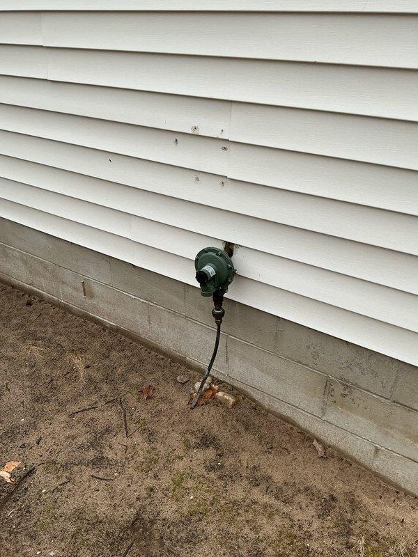 Conducted on-site assessment for standby generator installation. Evaluated existing electrical service panel configuration and identified suitable exterior mounting location on building with vinyl siding near concrete foundation. Documented current electrical infrastructure including main breaker panel with dual-column circuit breaker arrangement. Photographed proposed installation area and existing electrical components to develop accurate estimate for Kohler standby generator system. Customer expressed interest in whole-home backup power solution.