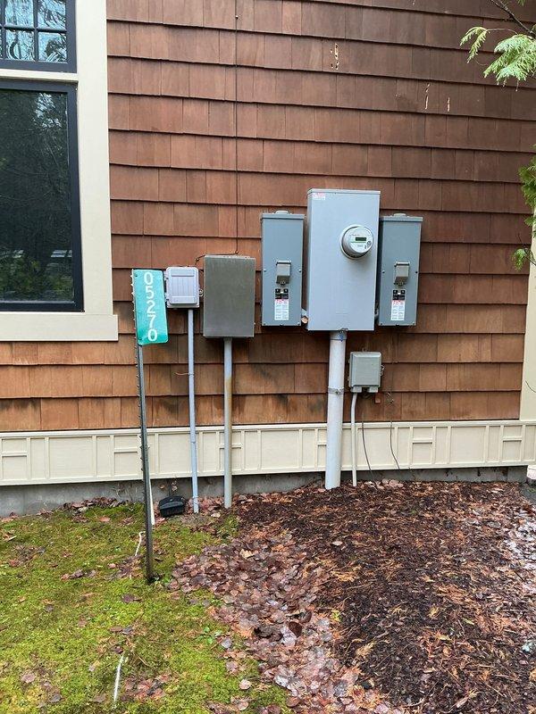 Conducted on-site assessment for replacement of two furnaces at residential property. Documented existing natural gas meter installation showing American brand meter dated 2005 with current reading of 0228 cubic feet, temperature compensated to 60°F. Verified gas supply infrastructure and connection points for future furnace installations. Photographed exterior electrical service panel configuration including main meter and multiple junction boxes to assess electrical capacity for new heating equipment. Evaluated utility access points and existing infrastructure to determine installation requirements and compatibility with proposed HVAC systems. Property accessed per client arrangement with findings documented through photographic evidence for estimate preparation.