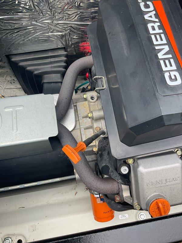 Completed annual inspection on Generac generator unit. Accessed internal components by removing top panel to perform comprehensive visual assessment of mechanical and electrical systems. Inspected motor/compressor assembly, capacitors, electrical connections, wiring harness, and mounting hardware for proper operation and signs of wear. Examined fuel line connections, hoses, and fittings for leaks or deterioration. Verified insulation material and housing integrity. Documented current condition of all accessible components through photographic records. Generator model and serial number information required for complete service documentation and will need to be obtained for records update.