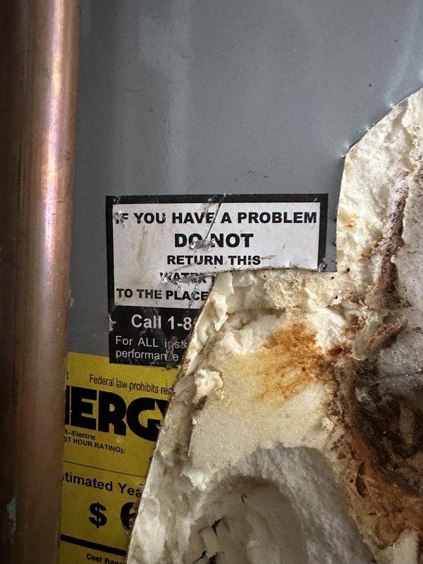 Performed comprehensive assessment of existing American Standard PROLINE water heater exhibiting severe corrosion, rust damage, and deteriorated insulation on lower tank sections, likely resulting from improper winterization and inadequate drainage procedures. Documented extensive water damage, mineral deposits, and structural compromise to tank exterior and insulation materials. Provided estimate options for replacement with 50-gallon and 80-gallon conventional tank water heaters, as well as tankless water heater alternative. Assessed plumbing system for additional freeze damage or compromised components throughout property due to improper seasonal shutdown. Prepared quote for water softener system installation to replace existing treatment equipment. Photographed damage conditions including rust staining, insulation failure, and debris accumulation at unit base for documentation and estimate preparation.