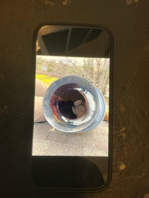 Responded to no-heat call for furnace blowing air but not heating to temperature. Upon inspection, found electrical control components and wiring connections at furnace location. Assessed system operation, documented equipment condition including exterior vent termination showing signs of corrosion and potential exhaust concerns. Captured diagnostic photos of control box wiring and vent pipe condition for service records.