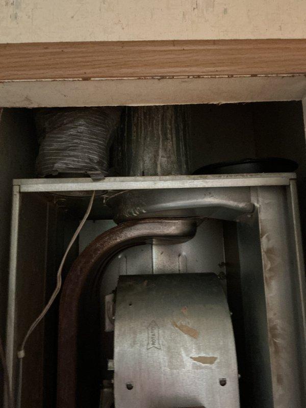 Conducted comprehensive furnace replacement estimate for residential property. Assessed existing HVAC system located in crawl space, documenting corroded heat exchanger pipes showing significant rust deterioration and aging flexible ductwork requiring replacement. Evaluated installation requirements including roof cap replacement for proper venting of new furnace system. Photographed existing equipment conditions and crawl space access for accurate proposal preparation.