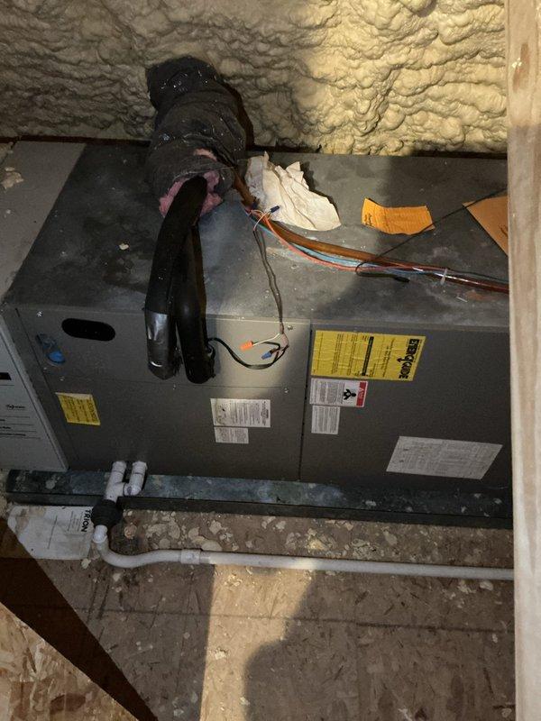 Conducted comprehensive estimate for air conditioning system replacement. Evaluated existing air handler unit located in attic space with spray foam insulation environment. Documented current equipment condition including air handler placement, refrigerant line connections, electrical wiring configurations, condensate drainage system with white PVC piping, and black flexible ductwork connections. Assessed installation space constraints, clearances around unit, concrete pad foundation, and accessibility for future equipment replacement. Photographed manufacturer labels, specification tags, and overall system layout to provide accurate equipment sizing and installation requirements for proposed AC system upgrade.