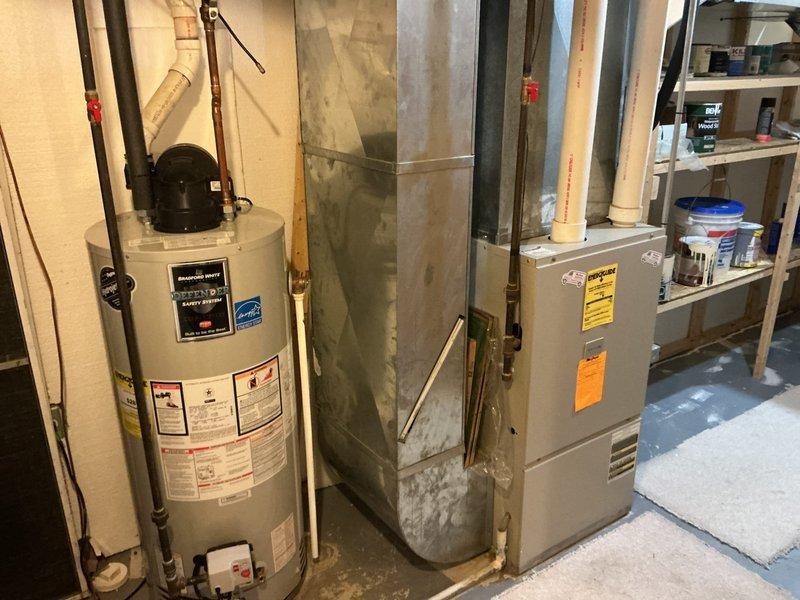 Conducted sales estimate for new air conditioning system replacement at residential property. Assessed existing HVAC setup in basement mechanical room, which currently includes a furnace unit with connected ductwork and water heater. Photographed current equipment configuration, noting the furnace installation with existing metal ductwork distribution system throughout the space. Evaluated the basement utility area layout, including available clearances, electrical service accessibility, and existing HVAC infrastructure to determine optimal placement and specifications for new AC unit installation. Discussed customer requirements and provided professional recommendations for air conditioning system options compatible with current furnace and ductwork configuration.
