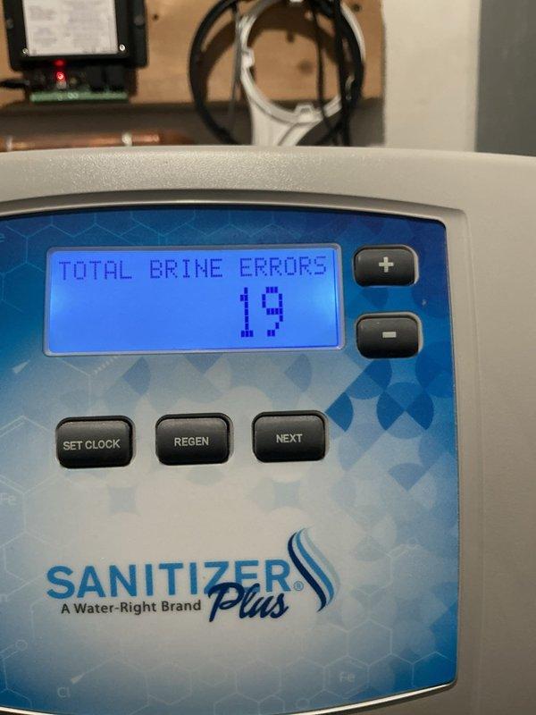Completed paid plumbing inspection of Water-Right Sanitizer Plus water treatment system. Documented control panel displaying 19 total brine errors and verified water hardness settings on digital display. System operational but error log indicates potential maintenance needs for brine tank or salt delivery components.