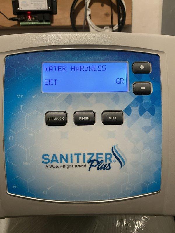 Completed paid plumbing inspection of Water-Right Sanitizer Plus water treatment system. Documented control panel displaying 19 total brine errors and verified water hardness settings on digital display. System operational but error log indicates potential maintenance needs for brine tank or salt delivery components.