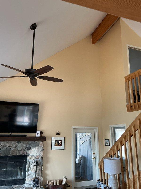 Conducted on-site evaluation for mini-split HVAC system installation in residential property with vaulted ceilings and open floor plan. Assessed electrical panel capacity and documented existing infrastructure, including main distribution panel with adequate breaker space for new equipment. Photographed installation areas and confirmed structural considerations for indoor unit placement in main living area with exposed beam construction and outdoor unit location requirements.