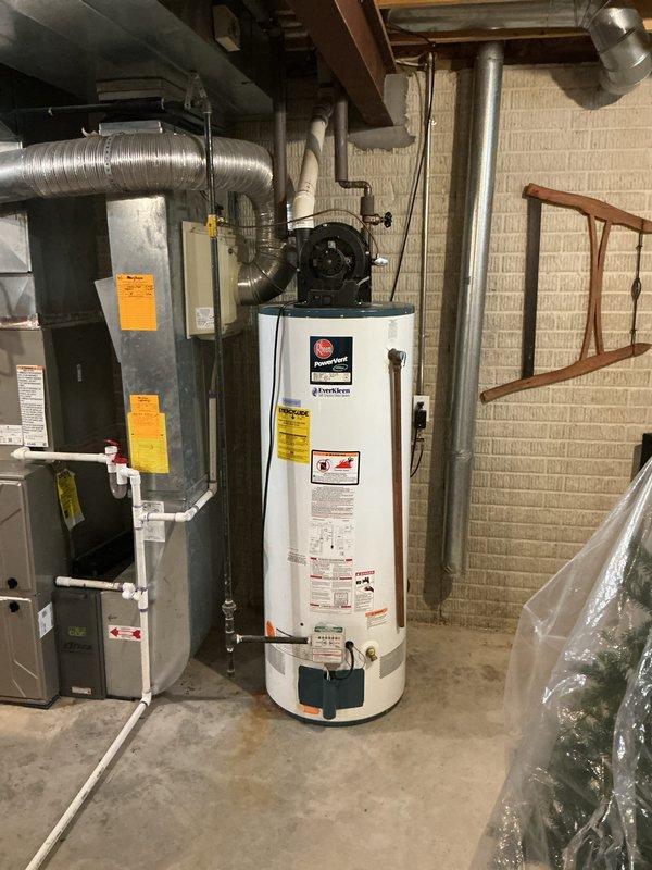 Completed estimate for replacement of 19-year-old Rheem PowerVent water heater with Everkleen self-cleaning system located in basement mechanical room. Documented existing unit configuration including power vent blower assembly, PVC venting, copper supply lines, and brass fittings to provide accurate replacement specifications and pricing options.