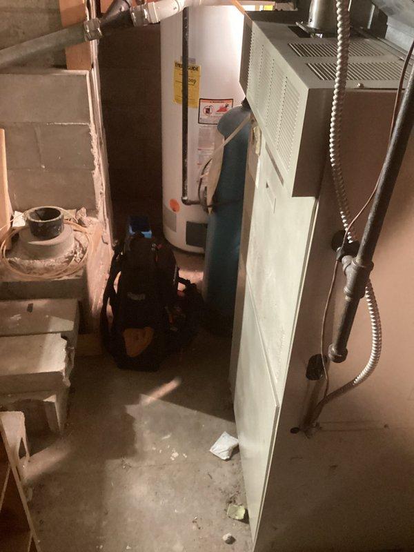 Responded to gas leak concern with reported high CO2 readings in residential property with 20+ year old equipment. Performed comprehensive safety inspection of basement mechanical room housing water heater and furnace unit, as well as crawl space area with exposed HVAC ductwork. Conducted combustion analysis and gas leak detection throughout all equipment and connection points, verified proper ventilation, and documented equipment condition with photos for service records.