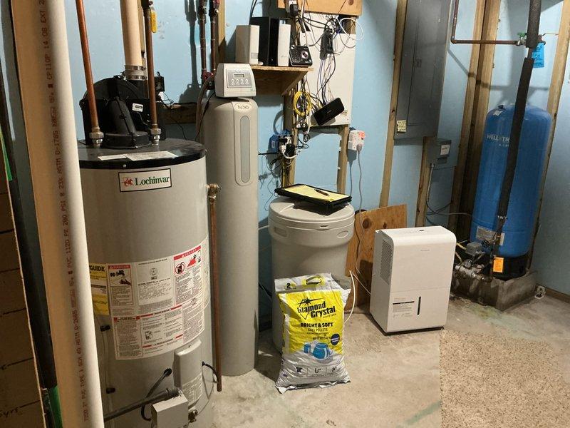 Conducted on-site evaluation of existing 50-gallon Lochinvar water heater in residential basement utility room and provided estimate for upgrading to larger 75-80 gallon capacity unit. Assessed current installation configuration including plumbing connections, gas line accessibility, venting requirements, and available clearances among existing mechanical equipment including water softener system and pressure tank. Documented existing equipment specifications and spatial layout with photographs to determine optimal replacement unit sizing and installation requirements.