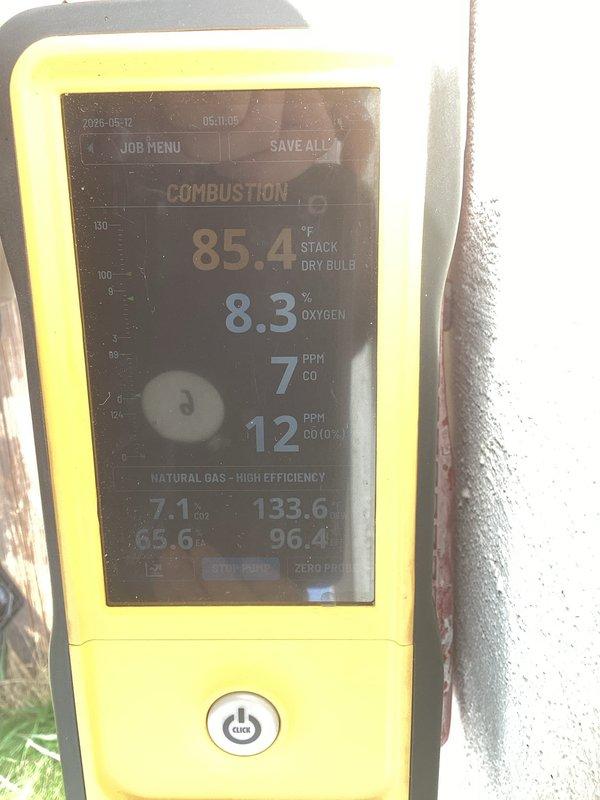 Responded to heating system safety concern regarding improper exhaust venting on 2019 Bryant furnace installation. County inspector identified that combustion exhaust gases were being discharged into the home's duct system rather than properly venting to the exterior. Performed combustion analysis testing which revealed 7 PPM CO in flue gases, 8.3% oxygen content, and 85.4°F stack temperature on natural gas high-efficiency system. Inspected PVC intake and exhaust venting configuration at furnace unit. Documented existing installation showing dual white PVC pipes extending from furnace top with improper connections allowing exhaust contamination of supply air. Corrected venting pathway to ensure combustion gases discharge safely outside the structure per manufacturer specifications and building code requirements. Verified proper system operation and confirmed no carbon monoxide present in living space after repairs completed.