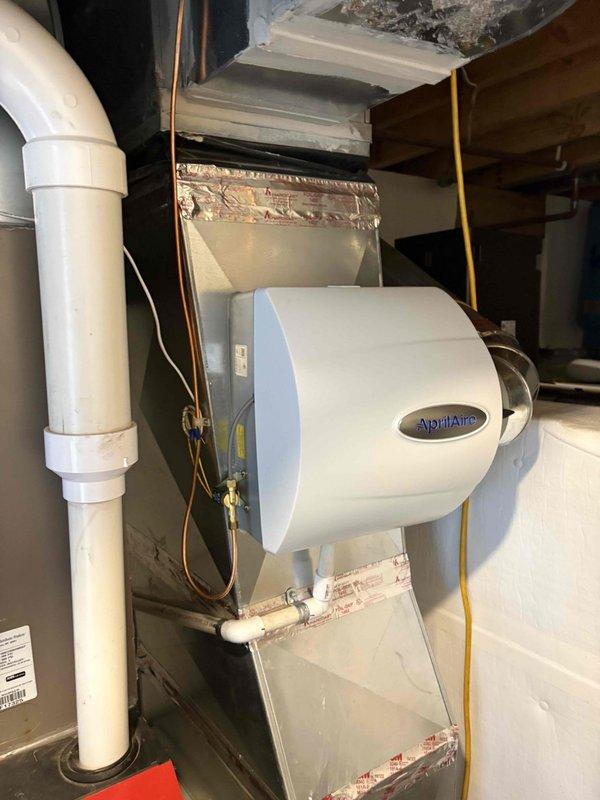 Installed AprilAire humidistat control unit on existing HVAC system as quoted. Mounted digital control panel with outdoor temperature compensation settings on wooden backing board adjacent to ductwork, completed all electrical connections, and verified proper operation with system.