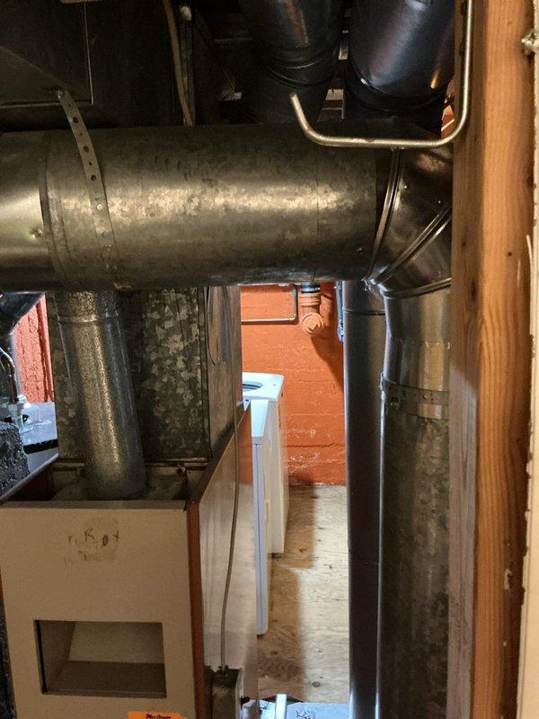 Conducted comprehensive AC estimate for two residential properties. Inspected existing HVAC systems in basement utility areas, documenting aged galvanized ductwork, furnace equipment, and metal supply/return ducts showing significant wear and surface deterioration. Noted extensive condensation on main refrigerant line indicating potential insulation deficiency and temperature differential issues requiring attention during system replacement or upgrade.